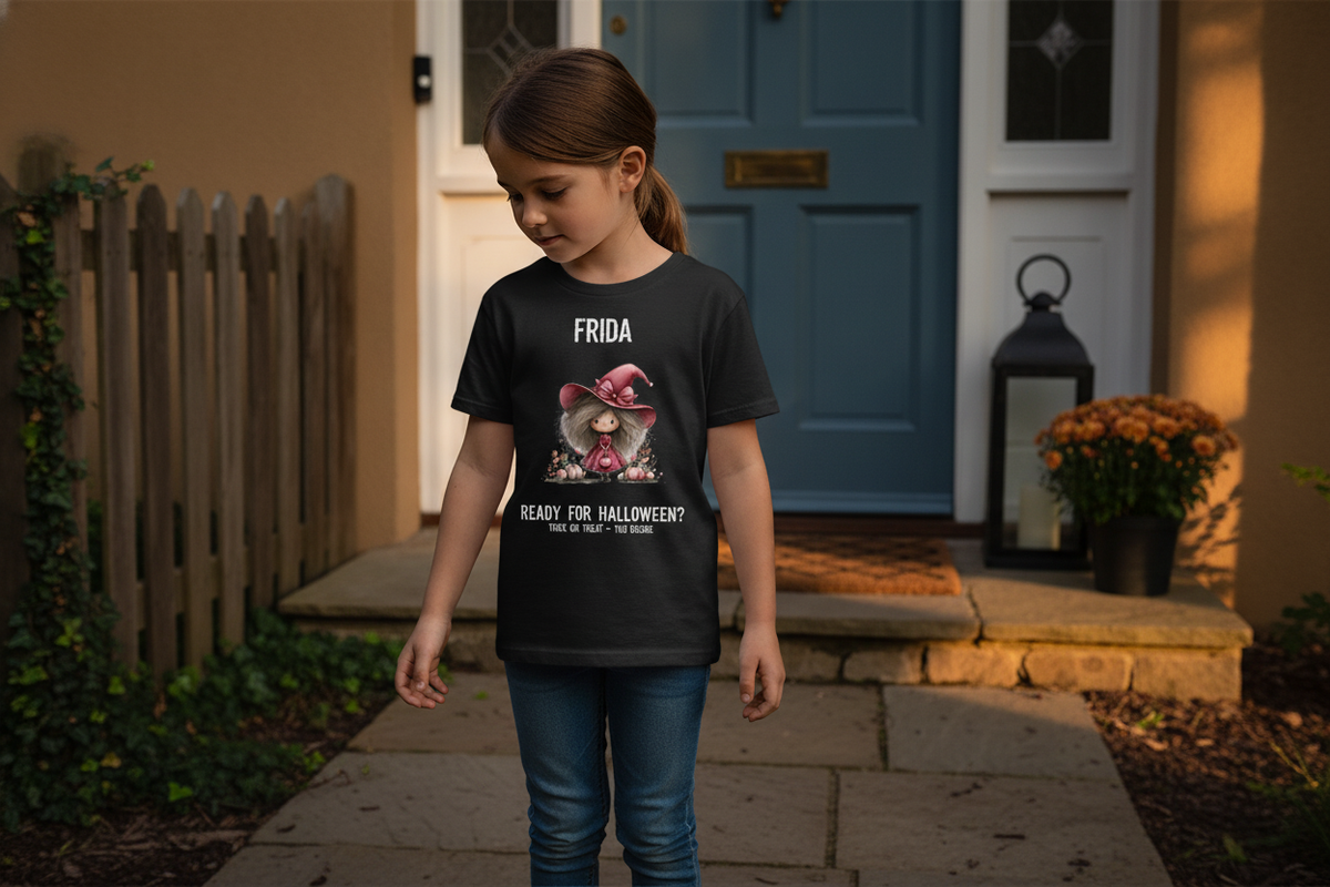 A young girl wears the black Girl in the Red Dress Halloween Tee while standing on a doorstep with a blue front door.