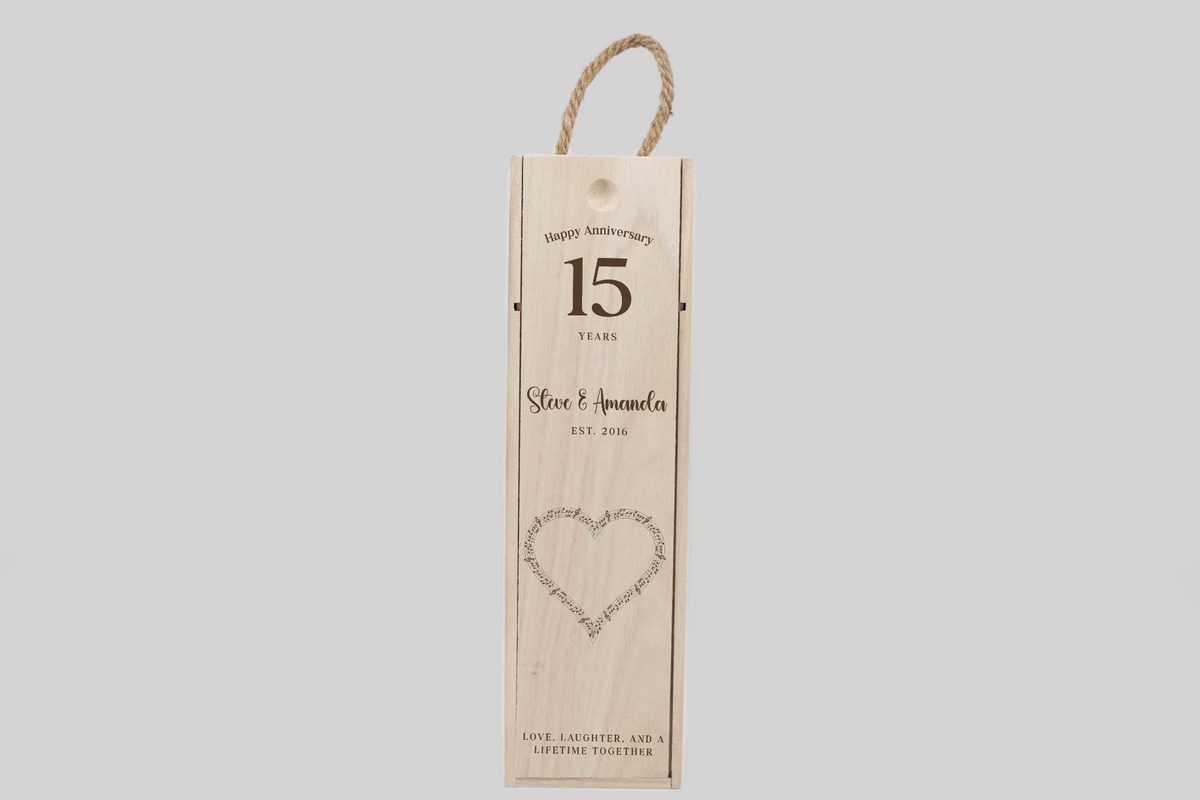 A low-angle shot of the musical heart anniversary wine box displays its full length and the engraved anniversary message.