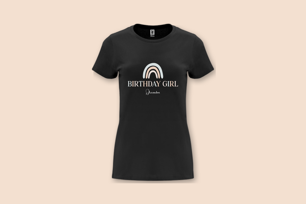 The Pearl Rainbow Birthday Tee in black, featuring a pastel rainbow and 'BIRTHDAY GIRL' text with a personalised name.