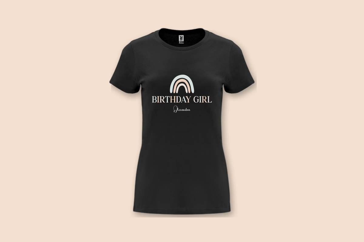 The Pearl Rainbow Birthday Tee in black, featuring a pastel rainbow and 'BIRTHDAY GIRL' text with a personalised name.