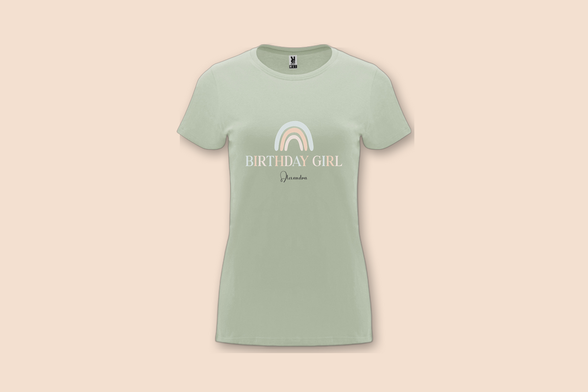 A light green Pearl Rainbow Birthday Tee, showcasing the pastel rainbow graphic and 'BIRTHDAY GIRL' text.