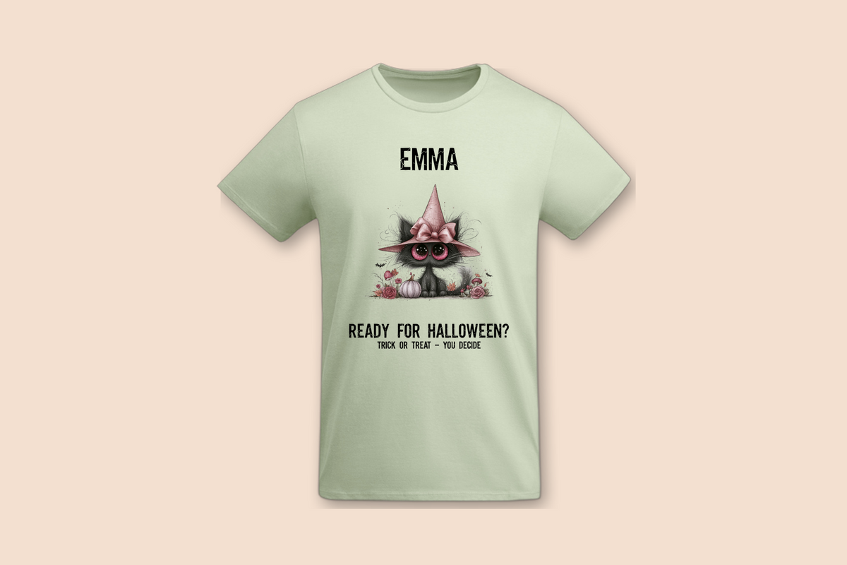 A light green Pink Pumpkin Cat - Halloween Tee is displayed flat, featuring a black cat wearing a pink witch hat.
